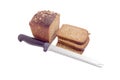 Brown bread with grain of sunflowers and kitchen knife Royalty Free Stock Photo