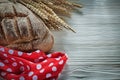 Brown bread rye ears red polka-dot fabric on white board Royalty Free Stock Photo