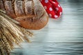 Brown bread wheat ears red polka-dot fabric on white board Royalty Free Stock Photo
