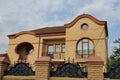 Brown brick attic of a private house with open iron balconies