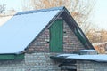 Brown brick attic of a rural house with a green wooden door Royalty Free Stock Photo