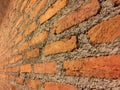Brown brick with bare plaster wall.