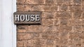 Brown brick wall background with inscription house copy space