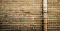 Brown brick wall with drainpipe background Royalty Free Stock Photo