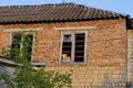 Brown bricks attic of an old house with a broken window Royalty Free Stock Photo