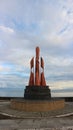 a brown bronze monument on the coast of Pasangkayu