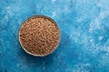 Brown buckwheat in boowl on ceramic background