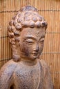 Brown Buddha statue with flowers