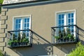 Brown building exterior of house or home with decorative brick and black balconies with small plants in midday sun Royalty Free Stock Photo