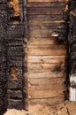 Brown burnt wall of house of wooden planks with embossed texture. background for copy space. concept of loss of real estate or Royalty Free Stock Photo