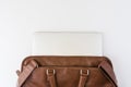 Brown business leather briefcase with notebook background