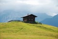 Brown cabin on hill in Alps