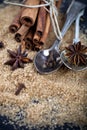 Brown cane sugar, cinnamon sticks and star anise closeup on black board background Royalty Free Stock Photo