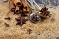 Brown cane sugar, cinnamon sticks and star anise closeup on black board background Royalty Free Stock Photo