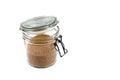 Brown cane sugar in glass jar isolated on white background Royalty Free Stock Photo