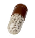 Brown capsule, pill close-up on a white background.