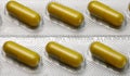 Brown capsules pill in blister pack arranged with beautiful pattern. Global healthcare concept. Antibiotics drug resistance. Royalty Free Stock Photo