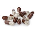 Brown capsules, pills close-up on a white background. Royalty Free Stock Photo