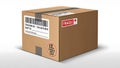 A brown cardboard box with a barcode label and fragile sticker on a white background Royalty Free Stock Photo