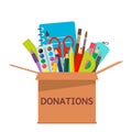 Brown cardboard box for donations full of stationery to a school for poor people