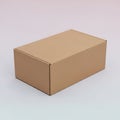 A brown cardboard box sitting on a white surface Royalty Free Stock Photo
