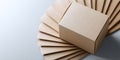 A brown cardboard box with a stack of folded paper on top, all against a light blue background Royalty Free Stock Photo