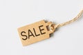 Brown cardboard price tag with sign sale on white background Royalty Free Stock Photo