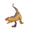 Brown carnotaurus toy on white background