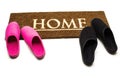 Brown carpet doormat with text Home and slippers.