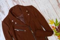 Brown cashmere coat autumn wooden background, autumn leaves. Fashion concept
