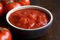 Brown ceramic bowl of chopped tinned tomatoes. Royalty Free Stock Photo