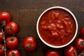 Brown ceramic bowl of chopped tinned tomatoes. Royalty Free Stock Photo