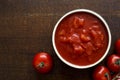 Brown ceramic bowl of chopped tinned tomatoes. Royalty Free Stock Photo