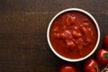 Brown ceramic bowl of chopped tinned tomatoes. Royalty Free Stock Photo