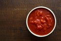 Brown ceramic bowl of chopped tinned tomatoes. Royalty Free Stock Photo