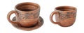 Brown ceramic cups from different angles, one on a saucer