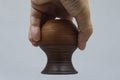 Brown ceramic jug upside down in hand close-up. Royalty Free Stock Photo