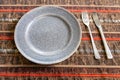 brown ceramic plate with fork and table knife Royalty Free Stock Photo