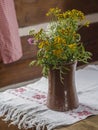 Brown ceramic vase with yellow white and pink field flowers on Royalty Free Stock Photo