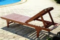 Brown chaise lounge by the outdoor pool Natural light during the day.