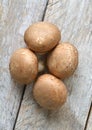 Brown champignon mushroom on a wooden background Royalty Free Stock Photo