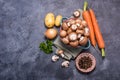 Brown champignons in bowl and vegetables for cooking, ingredients for soup or heatlhy vegan eating