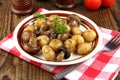 Brown champignons with rosemary potato and fork Royalty Free Stock Photo