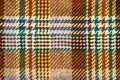 Brown checkered fabric with colored threads Royalty Free Stock Photo