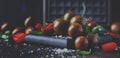 Brown cherry tomatoes with sea salt and green basil on dark table, autumn harvest, selective focus Royalty Free Stock Photo