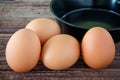 Brown chicken egg and iron pan on the table. Royalty Free Stock Photo