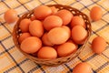 Brown chicken egg on vintage tablecloth and eggs in the basket Royalty Free Stock Photo