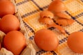 Brown chicken egg on vintage tablecloth and eggs in the basket Royalty Free Stock Photo