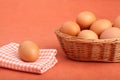 Brown chicken egg on vintage tablecloth and eggs in the basket Royalty Free Stock Photo