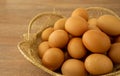 Brown chicken eggs in basket on brown wooden table Royalty Free Stock Photo